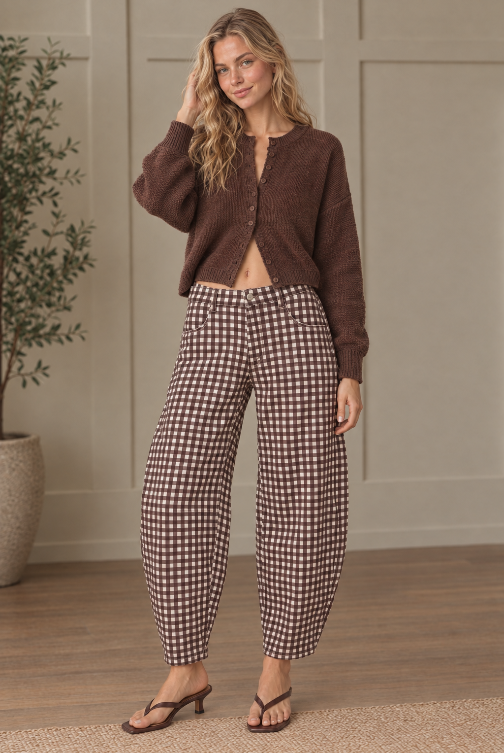 Brown and cream gingham barrel pants with curved legs, front pockets and tapered ankle hems, styled with a brown cardigan.