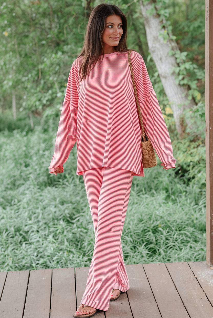 Model wearing red white stripe oversized drop shoulder pullover and wide-leg pants - candid walking pose showing wide-leg flare