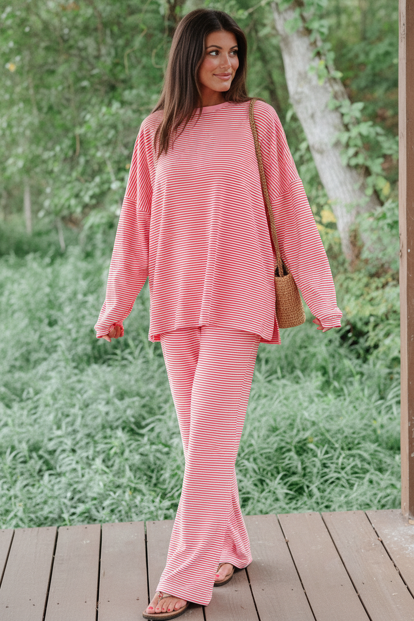 Model wearing red white stripe oversized drop shoulder pullover and wide-leg pants - candid walking pose showing wide-leg flare