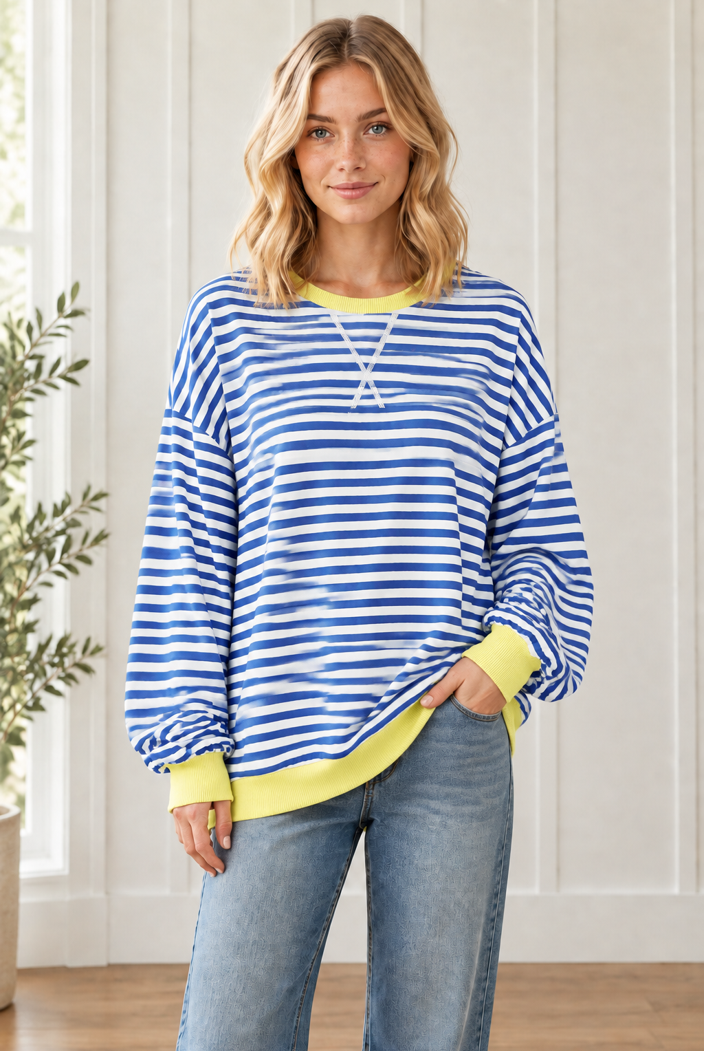 Three quarter view of Casual Cool Blue Stripe pullover with drop shoulders and yellow contrast trim, styled with jeans.