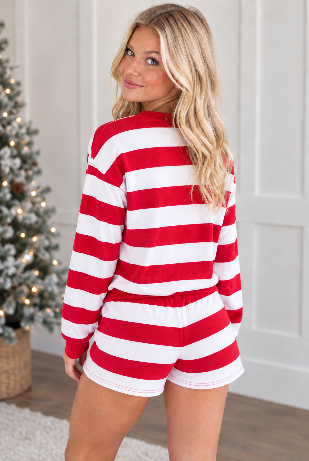 Rear view of red and white striped long sleeve pullover and matching holiday shorts with plain striped back