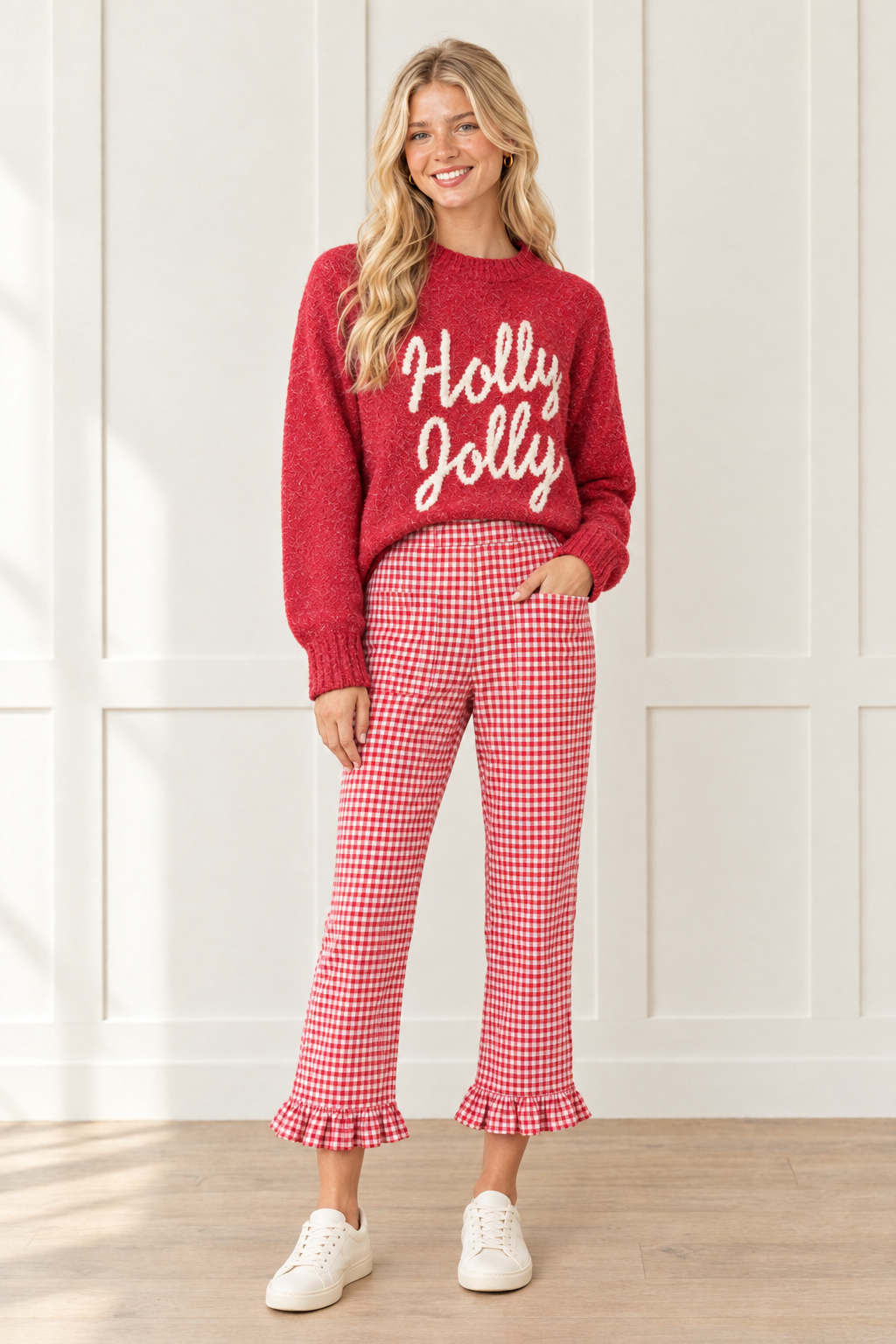 Front view of red gingham pants showing a large patch pocket, high waist, straight leg cut and ruffle trimmed ankle hems.