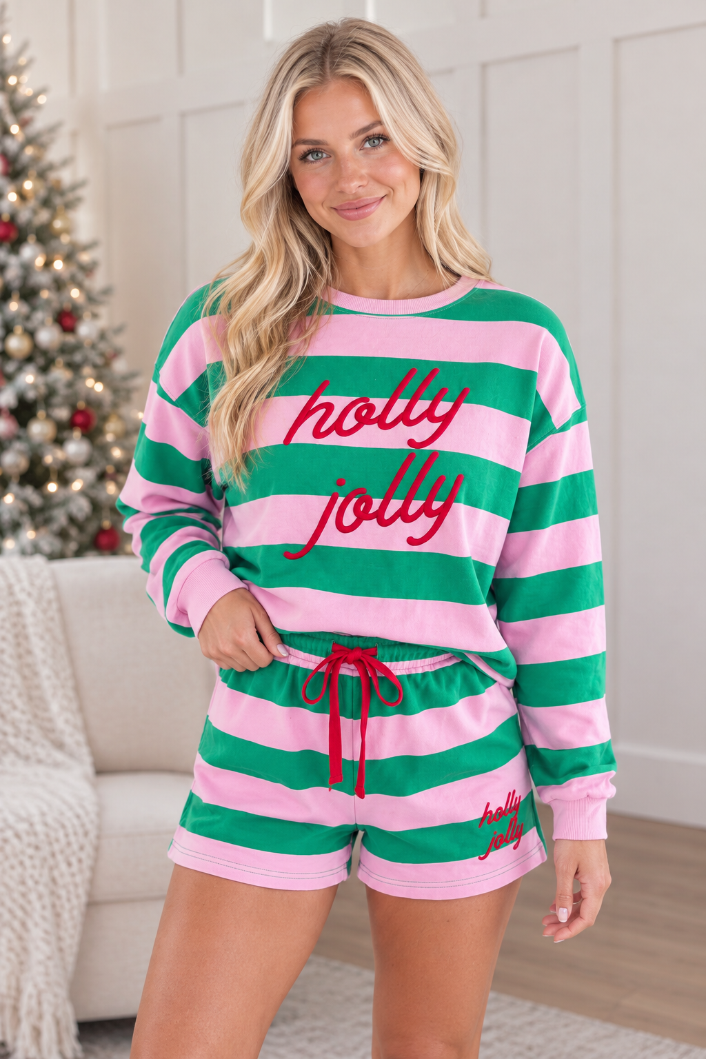 Three quarter view of pink and green stripe Holly Jolly long sleeve pullover and matching holiday shorts