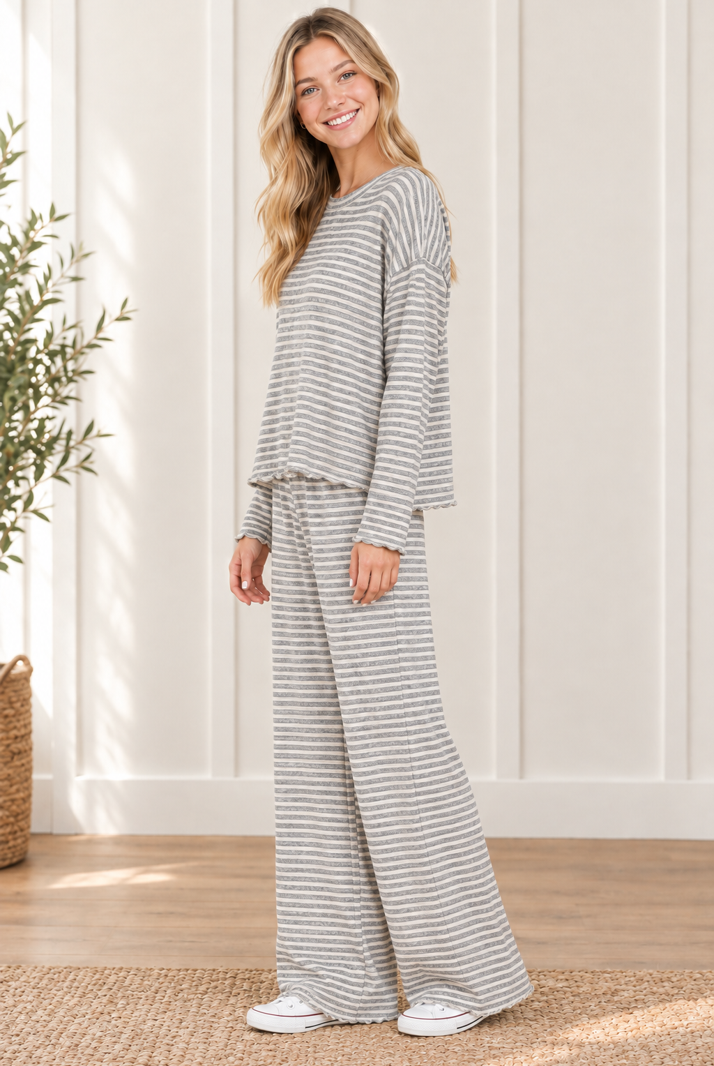 Side view of the Cloud Cozy gray and ivory striped lounge set showing the drape of the long sleeve boxy top and matching wide leg pants