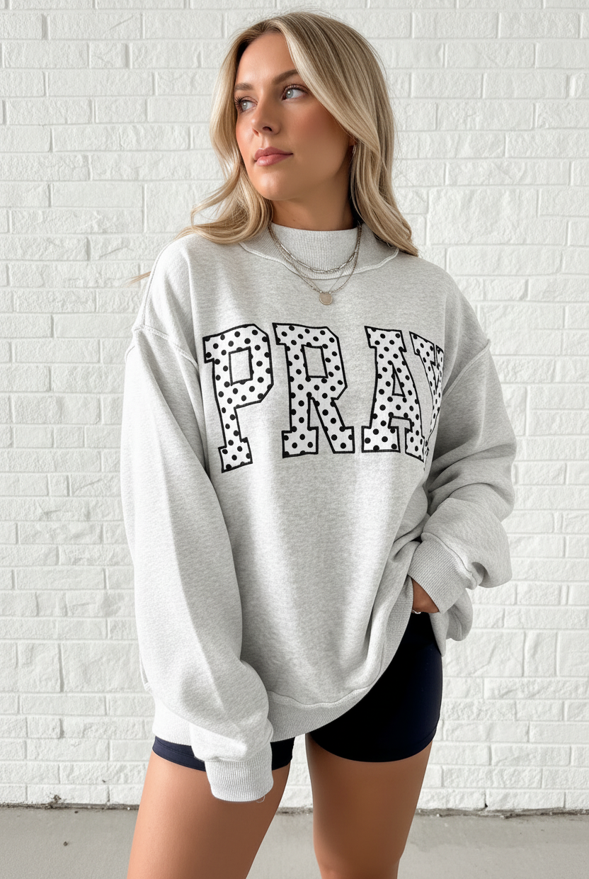 Close-up of PRAY polka dot embroidery detail on oversized heather gray mock neck sweatshirt, women's faith graphic sweatshirt