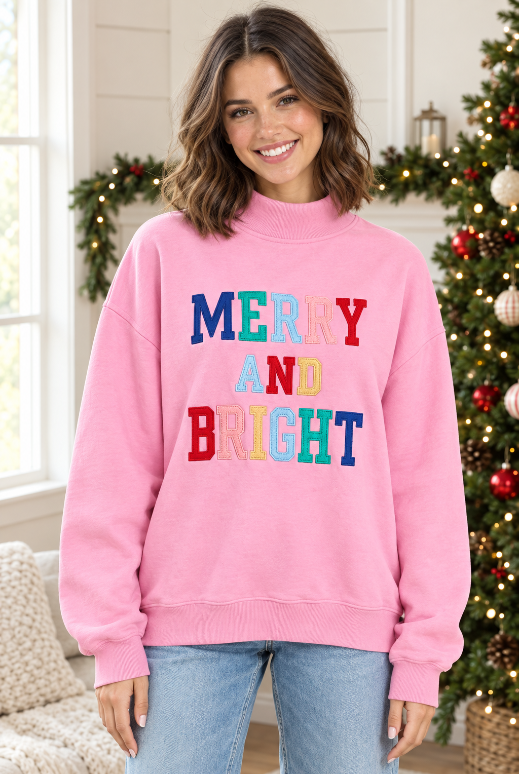 Pink Merry and Bright mock neck pullover, front view with multicolor stitched lettering and ribbed hem