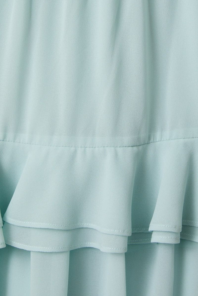 Close-up of a light blue fabric with ruffled layers.