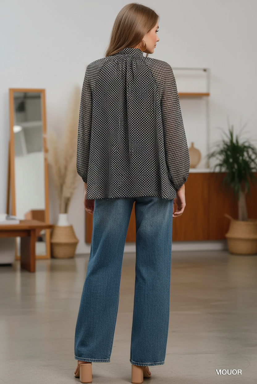 Back view of Umgee black and white polka dot sheer blouse with balloon sleeves, styled with high-waist wide-leg dark wash jeans and tan block heels, women's boutique top at Thread Bar Boutique