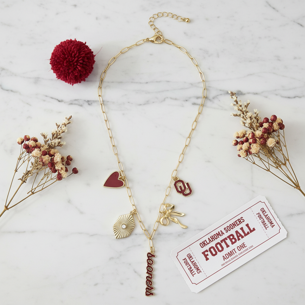 Official Oklahoma Sooners gameday charm necklace with layered team charms on a shiny gold paperclip chain, designed for bold Crimson and Cream fan style