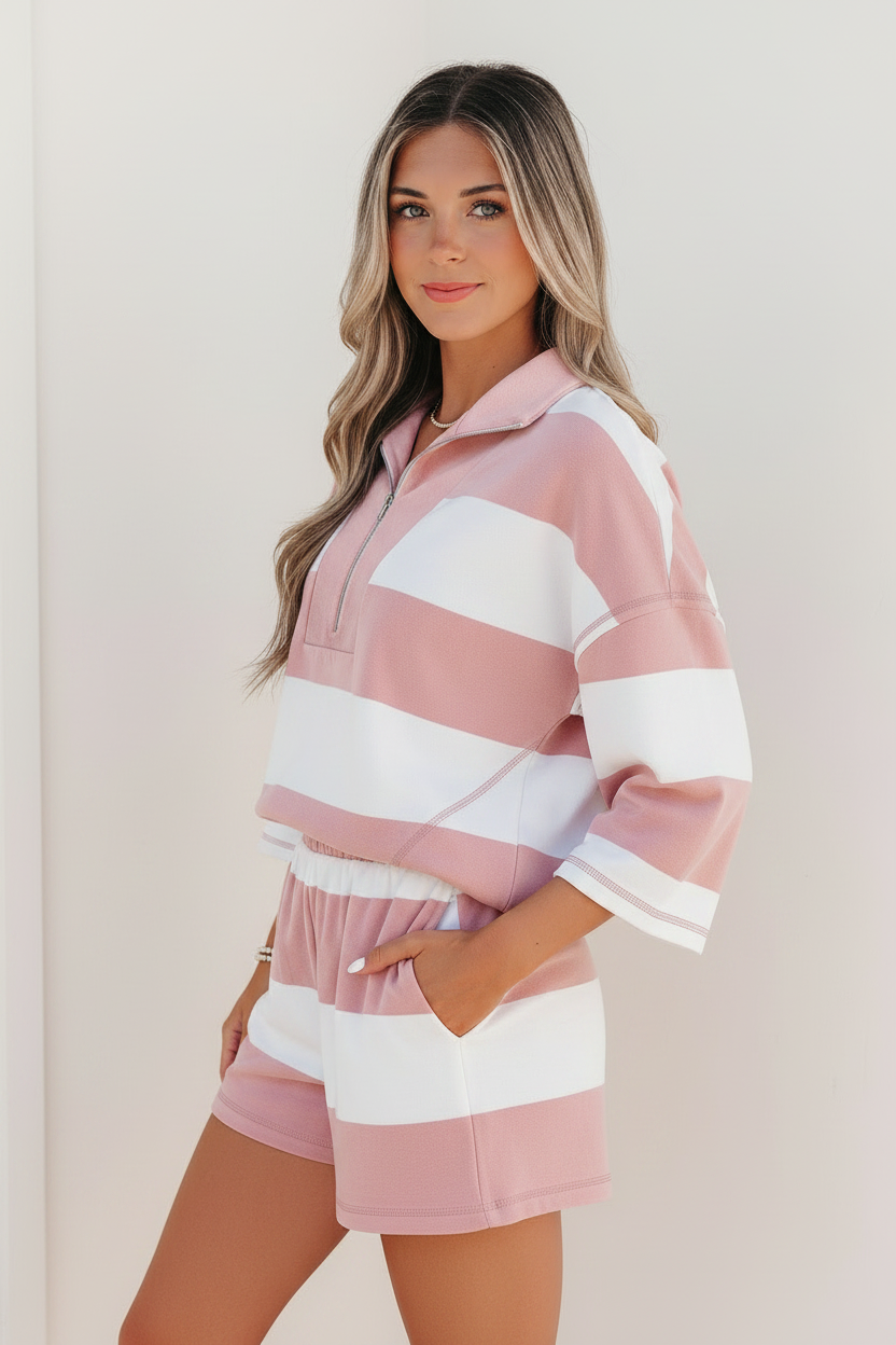 Pink striped two-piece set with metal half-zip placket, bracelet-length sleeves, and coordinating stripe print
