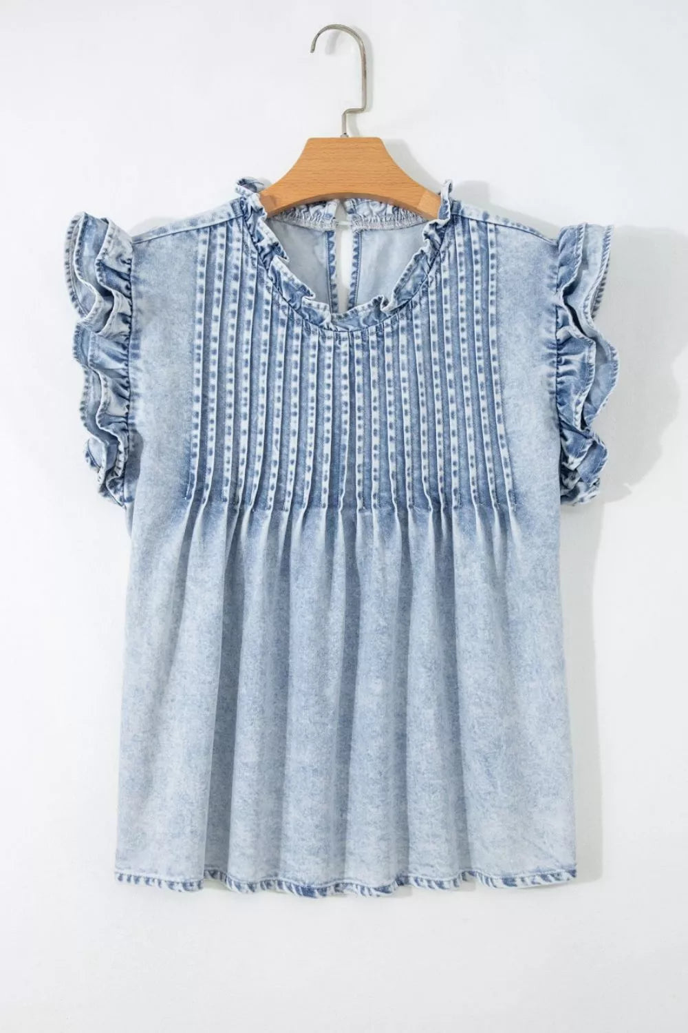Lightweight denim blouse with pleated front, ruffled neckline, and airy silhouette