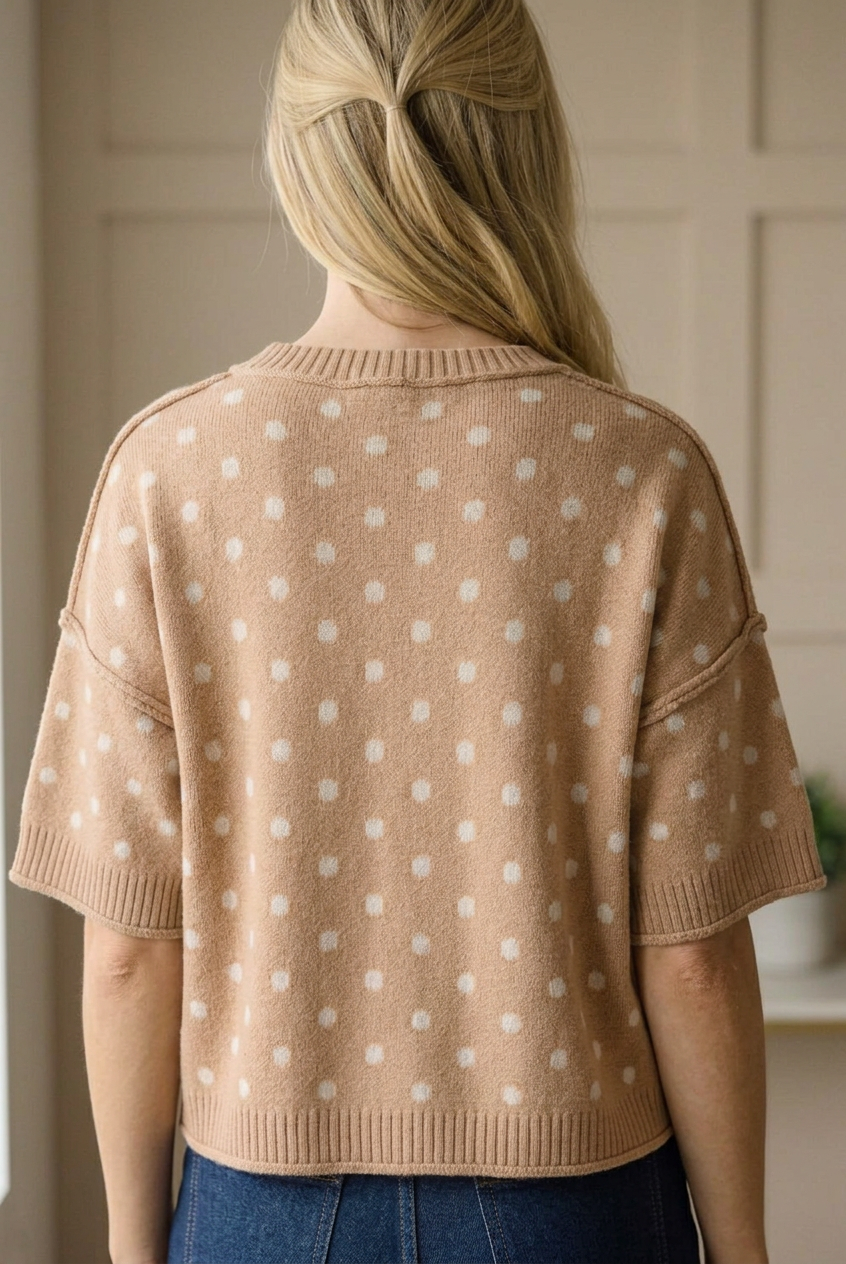 Back close-up of a camel polka dot short sleeve sweater top with ribbed neckline, cuffs, and hem
