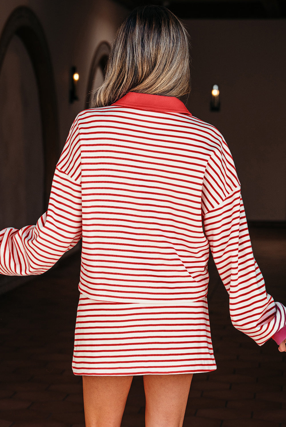 Trendy red stripe two-piece outfit from Thread Bar Boutique featuring collared pullover and skort with built-in shorts for comfort