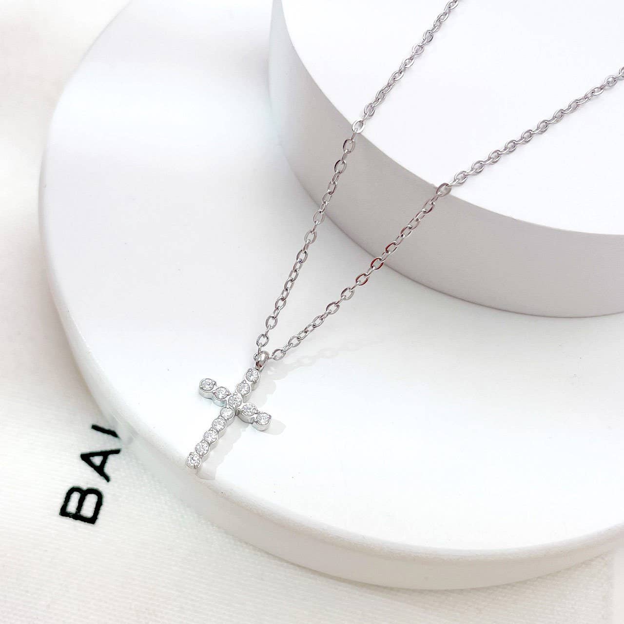 Minimalist cross pendant necklace with crystal rhinestones, lobster clasp chain, and water resistant stainless steel design