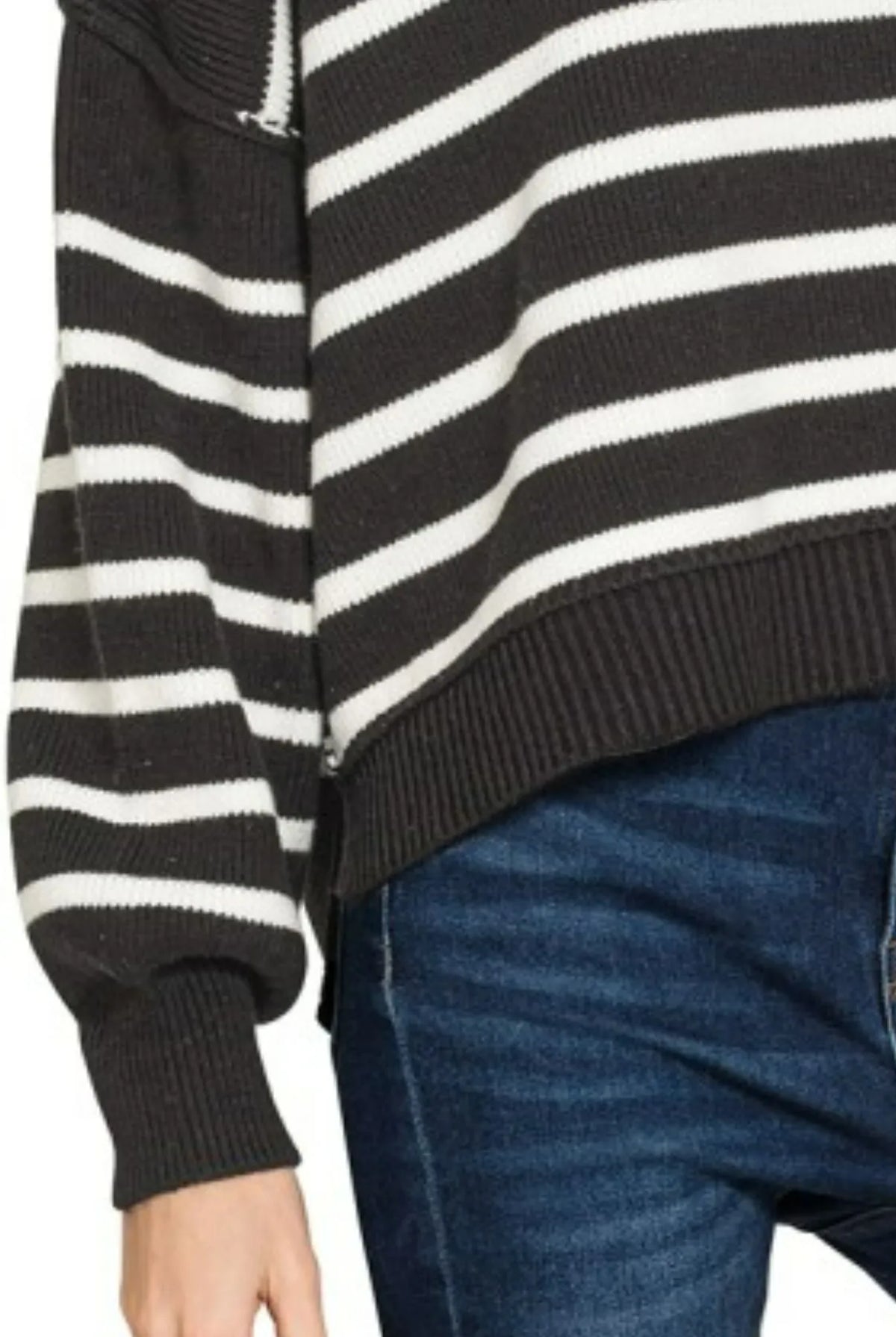 Close-up detail of Zenana Striped Sweater showing exposed seam along sleeve, ribbed cuff, and ribbed hem in black and white stripe kn