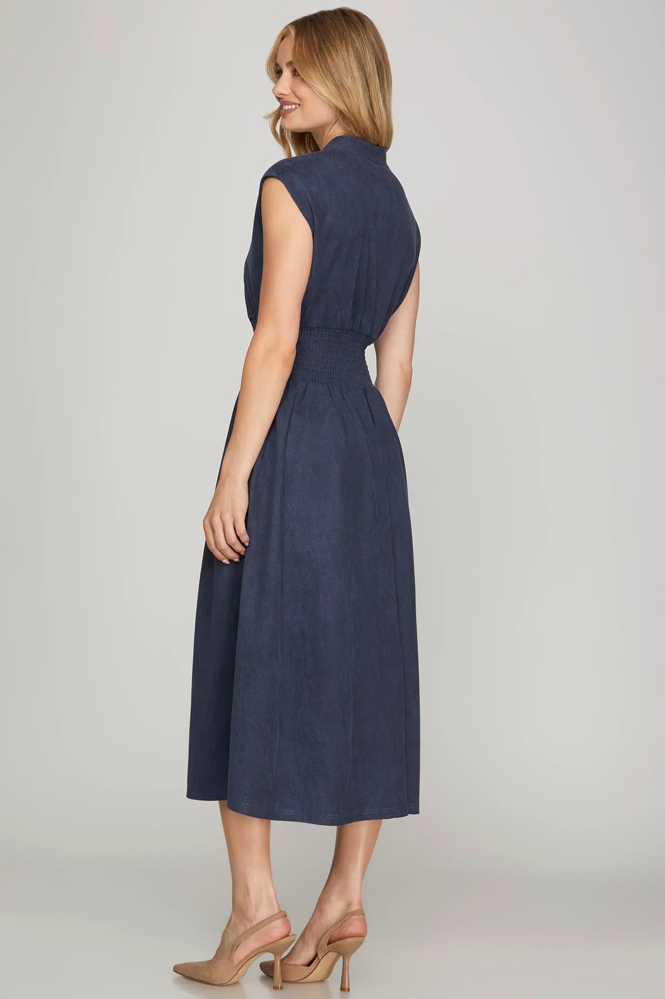 Fashion-forward suede midi dress with a zip front, V-neckline, smocked waist, side pockets, and cap sleeves, designed for versatile fall styling, casual chic outfits, and effortless everyday fashion.