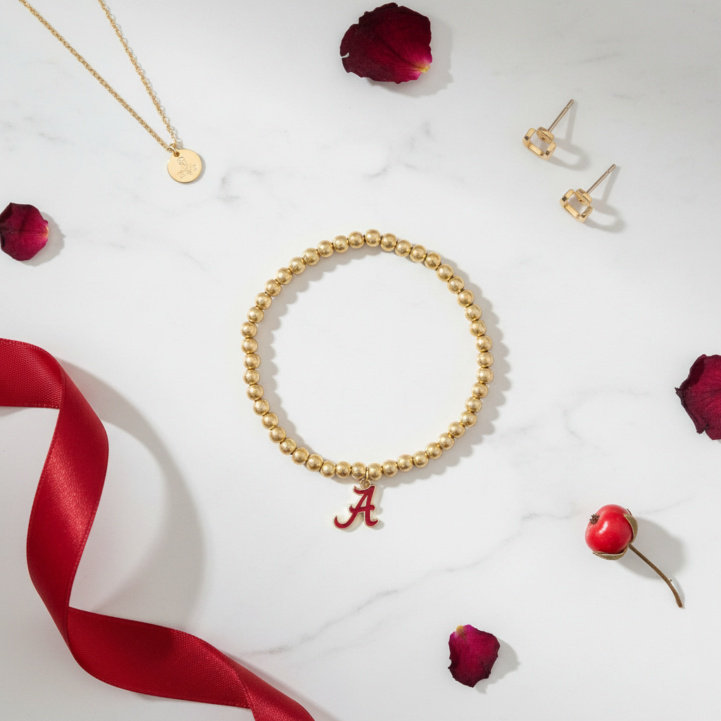 Alabama Crimson Tide Ball Bead Stretch Bracelet - flat lay on white marble with gold accents