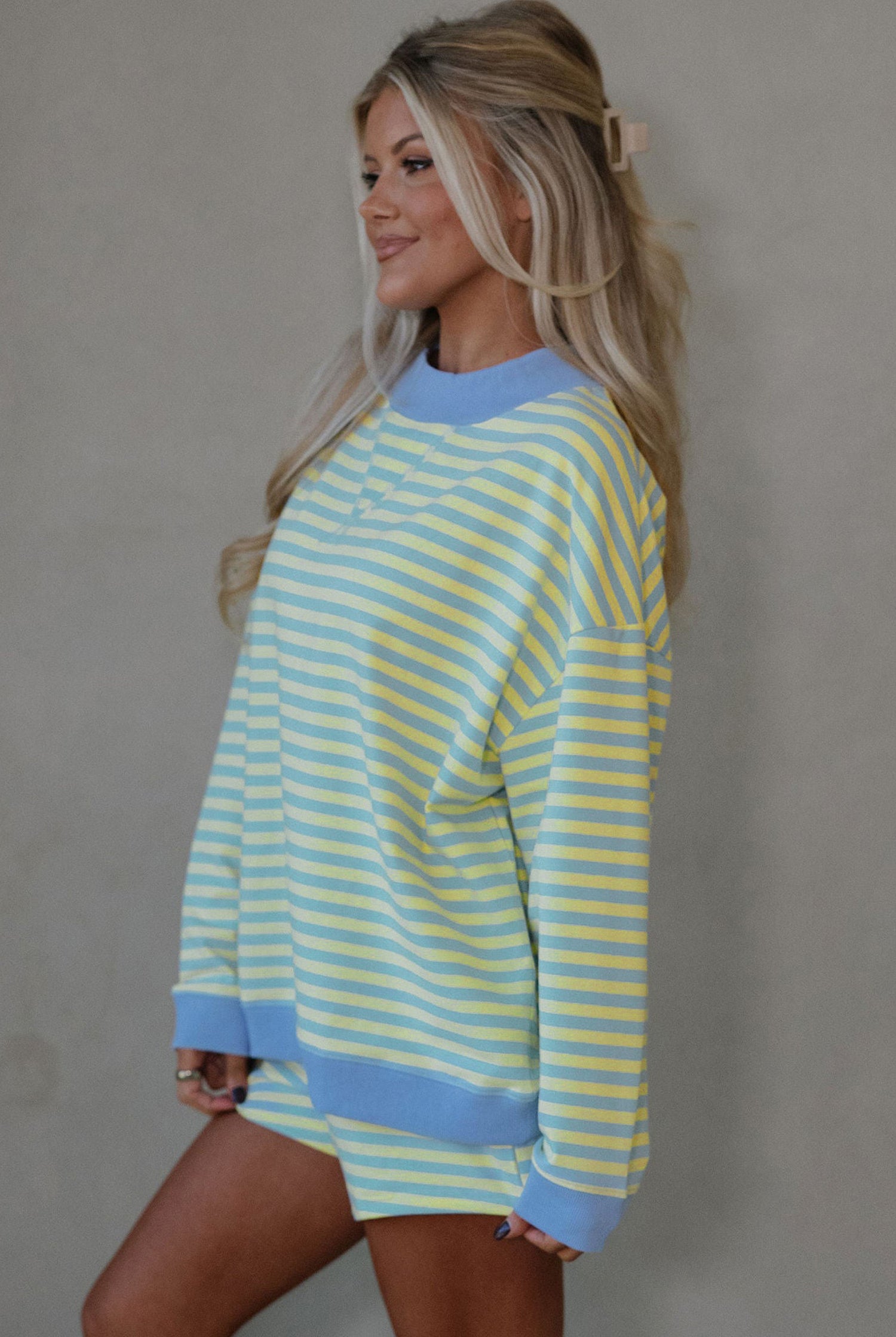 yellow and blue striped mock neck pullover and shorts matching set for women, trendy stripe two piece lounge outfit with color block trim, women’s striped matching set featuring mock neck top and loose fit shorts, casual boutique striped outfit set