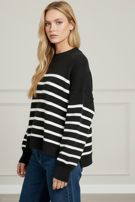 Upper body crop of Zenana Exposed Seam Striped Oversized Sweater — crew neckline, black and white stripe pattern, drop-shoulder silhouette