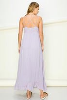 Model wearing an elegant lace maxi dress with a bustier-style bodice and flowing skirt, styled for a romantic formal occasion.
