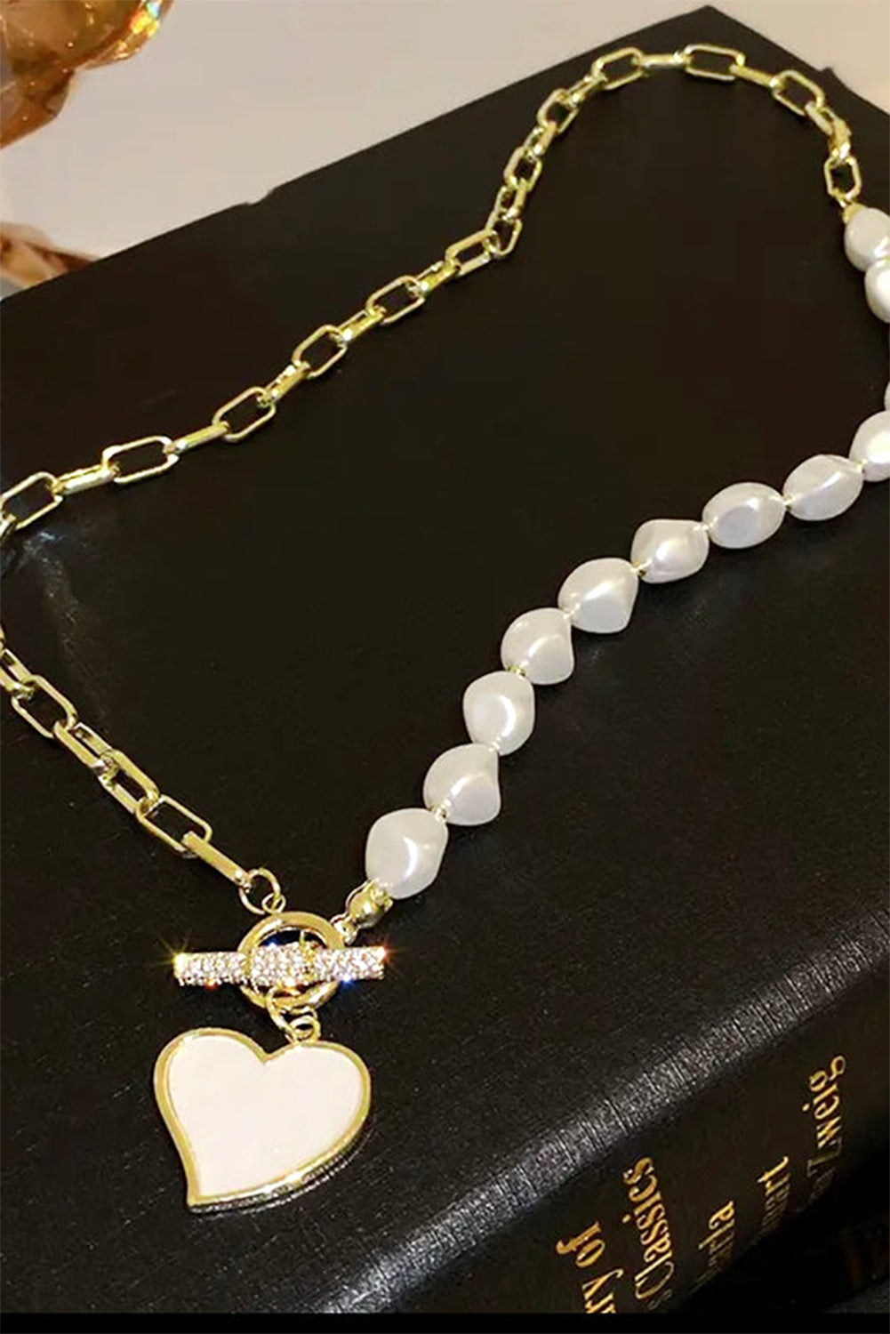 Necklace with heart pendant on a black surface