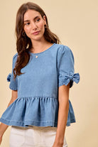 Short sleeve denim peplum shirt with charming bow detail at Thread Bar Boutique