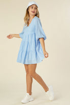 A charming gingham tiered dress featuring a V-neckline, puff 3/4 sleeves, and a flowy tiered silhouette. Fully lined with no stretch, perfect for casual outings, picnics, or brunch dates.