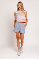 A fashionable round neck sweater vest with a sleeveless design, perfect for layering over blouses or wearing solo for a sleek, modern look. Ideal for creating preppy, casual, or chic outfits year-round.