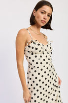 Women’s cream polka dot maxi dress styled for garden party Thread Bar Boutique