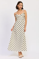 Cream polka dot bustier maxi dress with ties on straps and bustier. Thread Bar Boutique