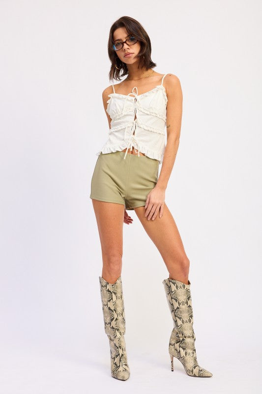 Women’s ivory ruffled tank top styled with high-waisted shorts
