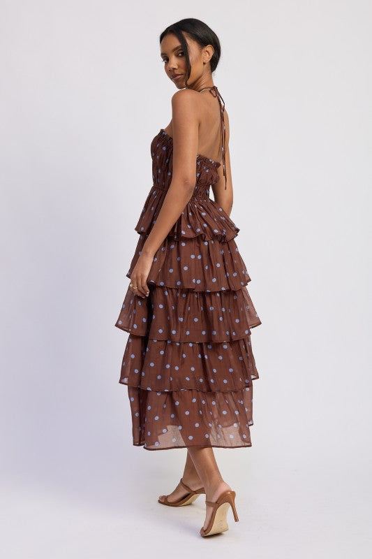 Woman wearing a brown tiered dress with light blue polka dots side and rear view