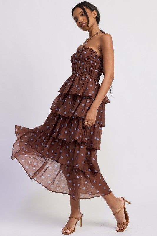 Woman wearing a brown tiered dress with light blue polka dots flowy layers