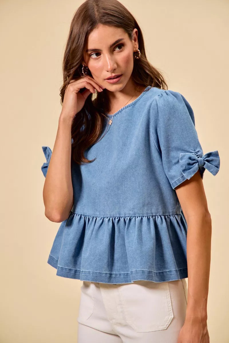 Casual denim peplum top with feminine bow accent from Thread Bar Boutique