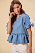 Casual denim peplum top with feminine bow accent from Thread Bar Boutique