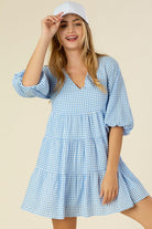 A charming gingham tiered dress featuring a V-neckline, puff 3/4 sleeves, and a flowy tiered silhouette. Fully lined with no stretch, perfect for casual outings, picnics, or brunch dates.
