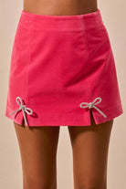 Rhinestone bow detail velvet mini skirt from Thread Bar Boutique with hidden back zipper and luxe soft fabric.