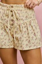utter yellow button pink tuck shorts with floral print close up