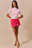 Thread Bar Boutique rhinestone embellished velvet skirt with structured fit and feminine bow slit detailing for cocktail events.