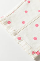 White fabric with pink polka dots on a white background