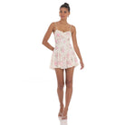A model wearing a floral lace mini dress with a sweetheart neckline, adjustable spaghetti straps, and a skater-style silhouette. The dress is fully lined, and features delicate lace fabric, perfect for a feminine and trendy look.