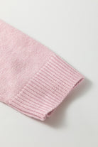 Close-up of a pink knitted garment on a light gray background