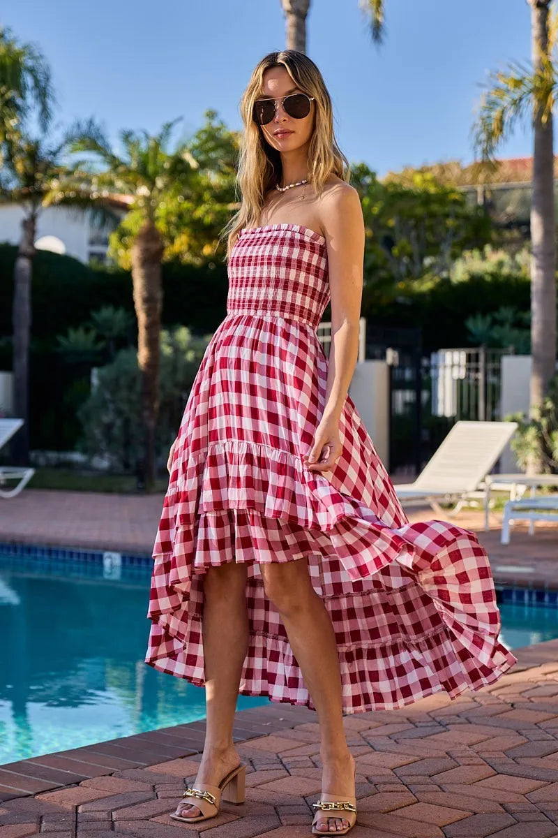 Woman wearing an off-shoulder gingham smocked dress with a flowy silhouette, perfect for casual summer outings, brunch, or vacation wear