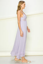 Model wearing an elegant lace maxi dress with a bustier-style bodice and flowing skirt, styled for a romantic formal occasion.