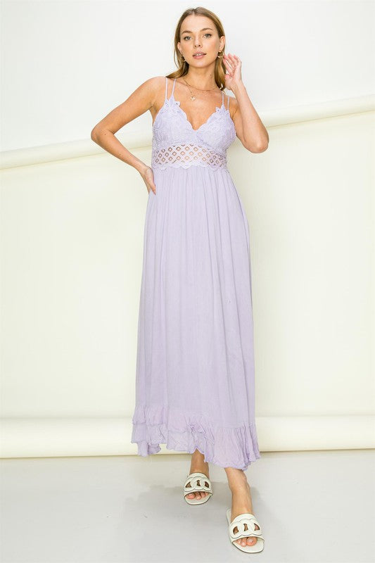 Model wearing an elegant lace maxi dress with a bustier-style bodice and flowing skirt, styled for a romantic formal occasion.