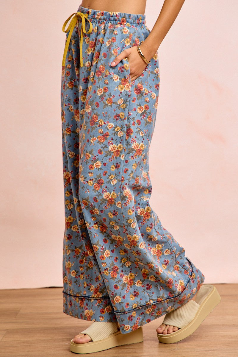 Side view of floral wide leg pants showing flowing silhouette and relaxed fit on model