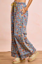 Side view of floral wide leg pants showing flowing silhouette and relaxed fit on model