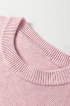 Close-up of a pink knitted sweater collar on a light background
