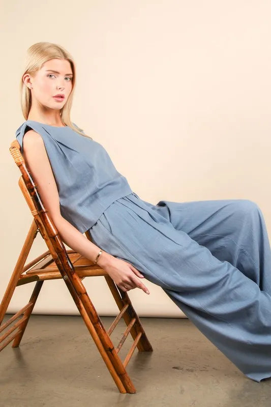 Woman wearing solid woven top and pants set 