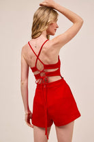 Fitted Game Day romper with lace-up open back design